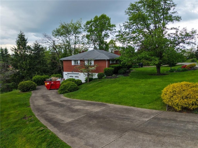 view of front facade featuring concrete driveway, a garage, a chimney, a front lawn, and brick siding
