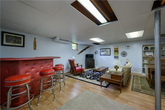 115 River Ave, Glenfield, PA 15143 - living room featuring wood finished floors, a dry bar, a drop ceiling, and baseboards