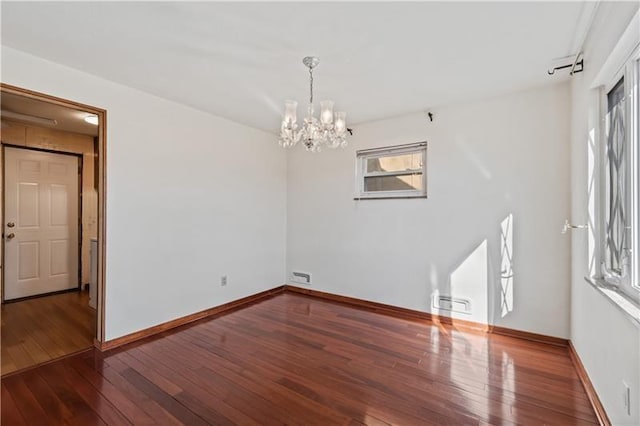 149 Fairfax Rd, Forest Hills Boro, PA 15221 - unfurnished room with a chandelier, plenty of natural light, hardwood / wood-style flooring, and baseboards
