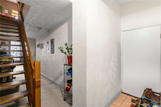 stairway featuring tile patterned flooring