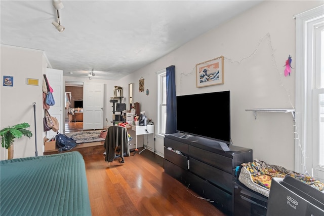 living area featuring wood finished floors and track lighting