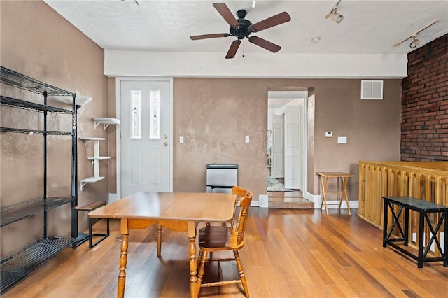 office with wood finished floors, a ceiling fan, and track lighting