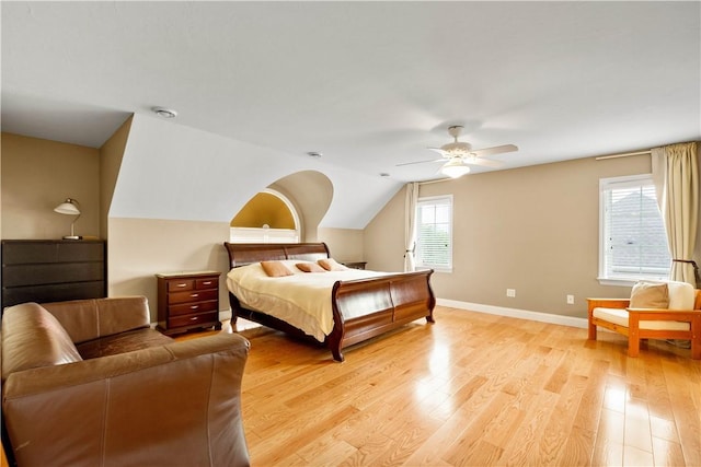 bedroom with light wood finished floors, baseboards, ceiling fan, and lofted ceiling
