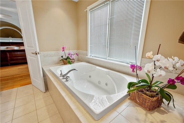 bathroom featuring a whirlpool tub and tile patterned floors