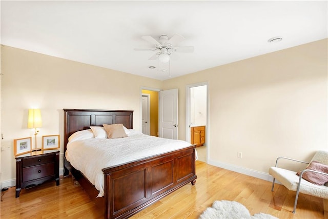 bedroom with baseboards, light wood finished floors, ensuite bathroom, and ceiling fan