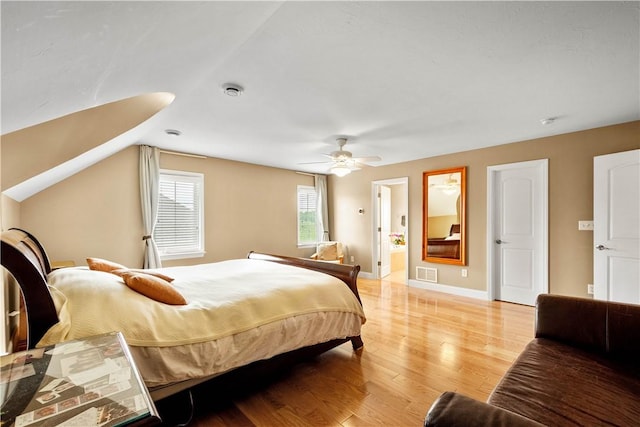bedroom with light wood-style floors, a ceiling fan, and baseboards