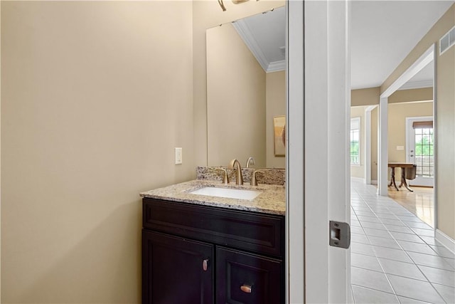 bathroom featuring ornamental molding, tile patterned flooring, baseboards, and vanity
