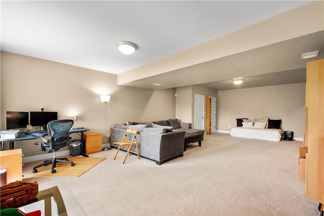 living area featuring light carpet, a desk, and baseboards