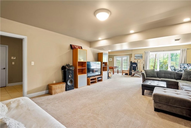 living area featuring light colored carpet, plenty of natural light, and baseboards