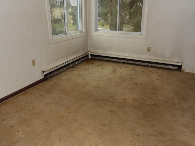 carpeted spare room with baseboards