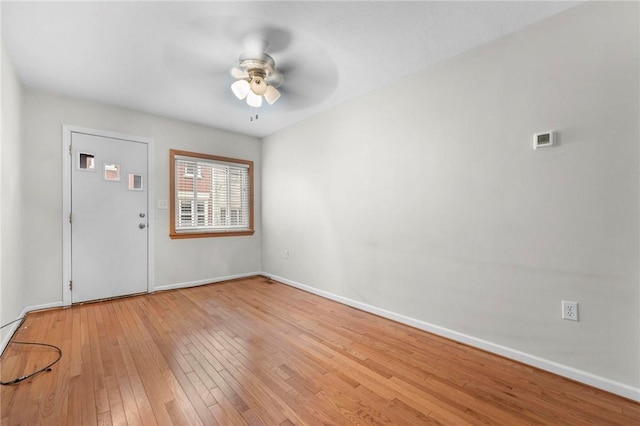 foyer entrance with a ceiling fan, hardwood / wood-style floors, and baseboards