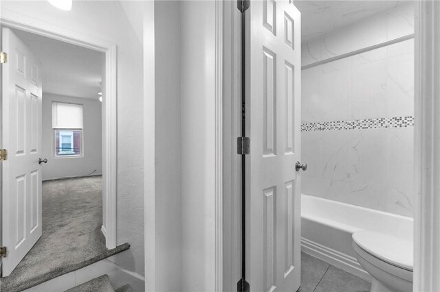 full bathroom featuring toilet, bathing tub / shower combination, and tile patterned flooring