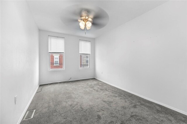 empty room featuring ceiling fan, carpet flooring, and baseboards