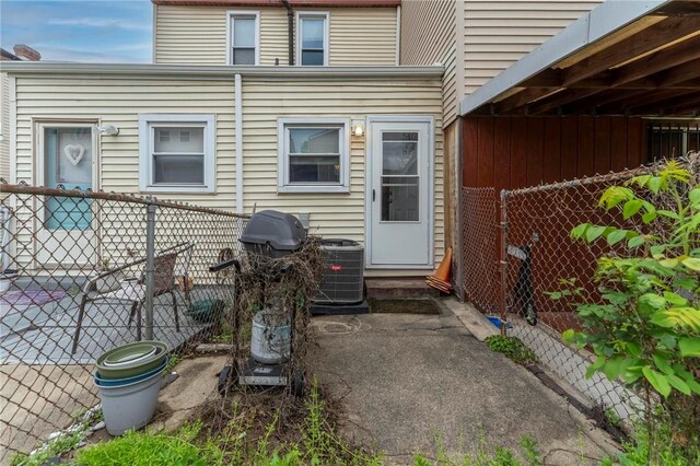 back of house with fence, central AC, and a patio area