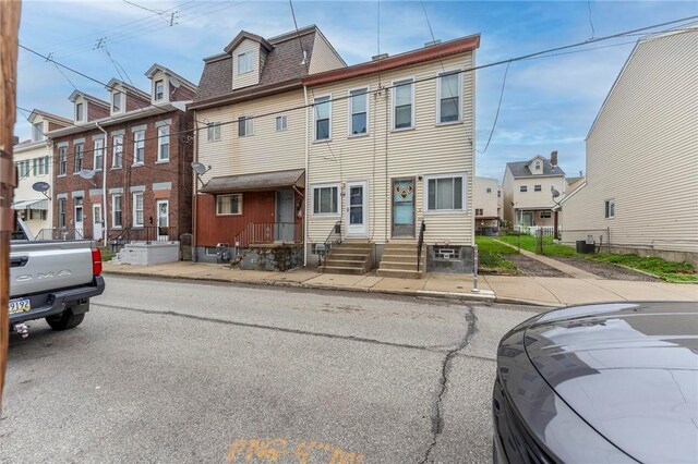multi unit property with a residential view and a shingled roof