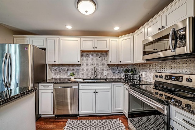 1611 Kenzie Dr, Robinson Twp Nwa, PA 15205 - kitchen featuring appliances with stainless steel finishes, a sink, white cabinetry, dark stone countertops, and backsplash