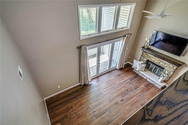 1611 Kenzie Dr, Robinson Twp Nwa, PA 15205 - living area with wood finished floors, baseboards, a stone fireplace, a high ceiling, and a ceiling fan