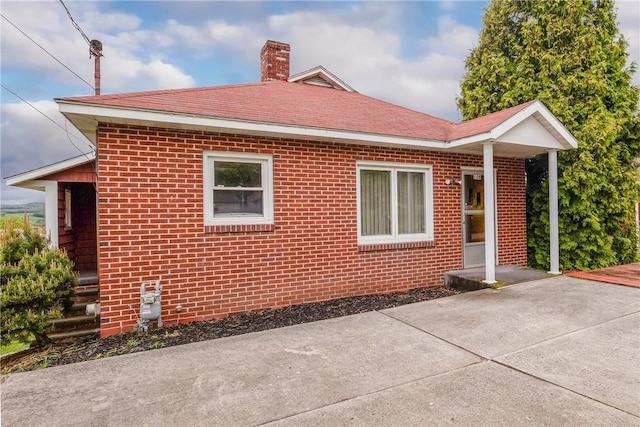 108 Gay St, Salisbury, PA 15558 - view of side of property featuring brick siding, a chimney, a patio, and a shingled roof