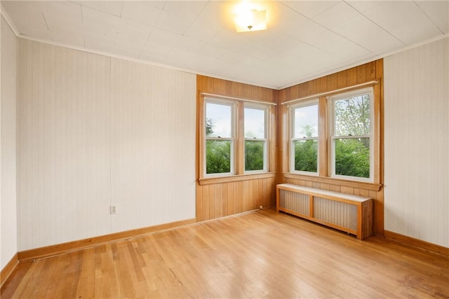 108 Gay St, Salisbury, PA 15558 - empty room with radiator, wood finished floors, baseboards, ornamental molding, and wooden walls
