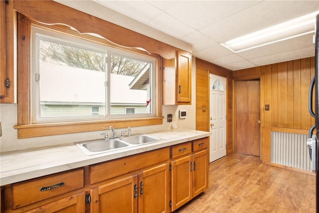 108 Gay St, Salisbury, PA 15558 - kitchen with a sink, wooden walls, light countertops, light wood-type flooring, and brown cabinets
