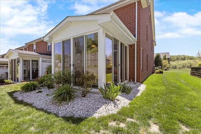 216 Settlers Ct, Peters Twp, PA 15367 - view of property exterior with a sunroom, brick siding, and a yard