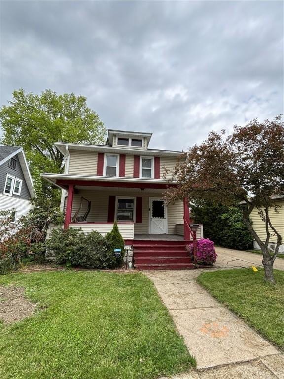 traditional style home with covered porch and a front yard