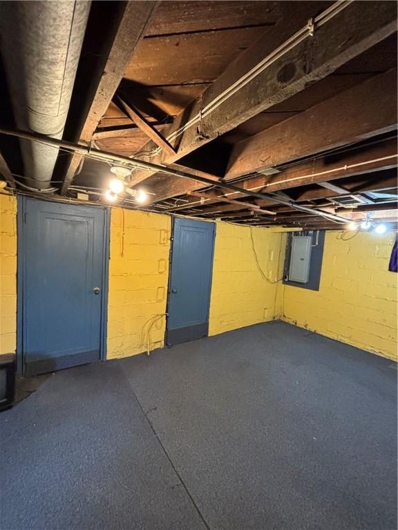 unfinished basement featuring electric panel
