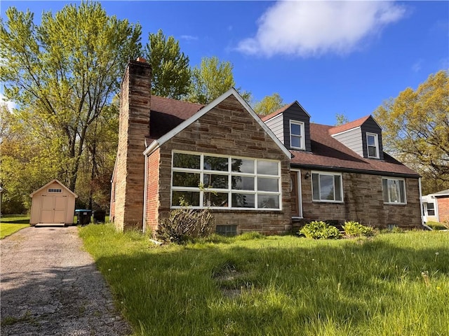 1350 George St, Hermitage, PA 16148 - rear view of house with a storage unit, stone siding, an outbuilding, and a chimney