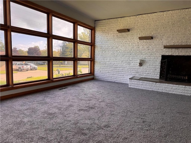 1350 George St, Hermitage, PA 16148 - unfurnished living room featuring a brick fireplace, carpet, plenty of natural light, and brick wall