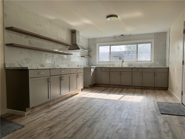 1350 George St, Hermitage, PA 16148 - kitchen with open shelves, gray cabinetry, wall chimney range hood, light wood-style floors, and backsplash