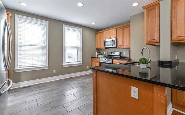 608 Broad St, Sewickley, PA 15143 - kitchen featuring stainless steel appliances, a sink, dark stone countertops, recessed lighting, and baseboards