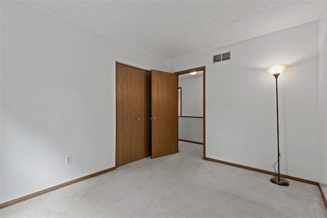 567 Brandywine Dr, Cranberry Twp, PA 16066 - unfurnished bedroom with light colored carpet, baseboards, a textured ceiling, and a closet