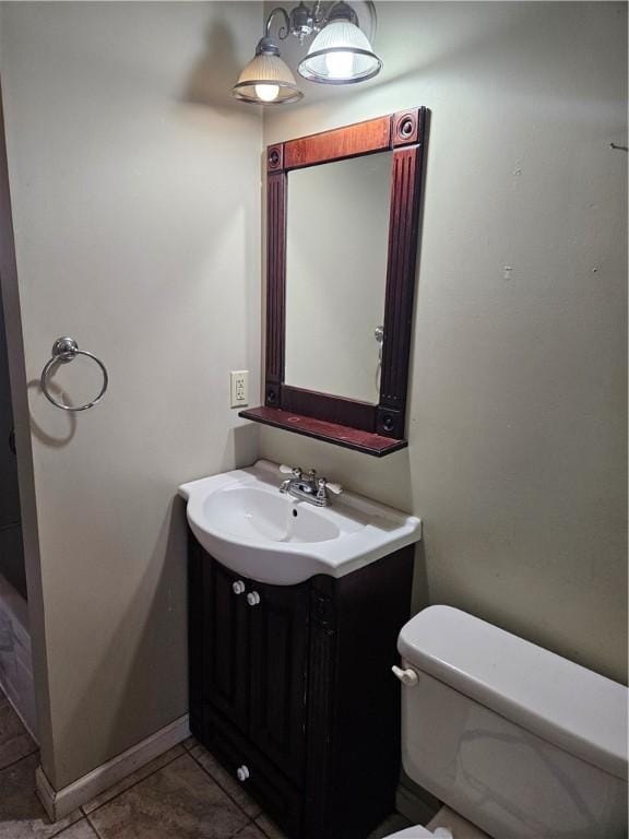 half bathroom featuring toilet and vanity