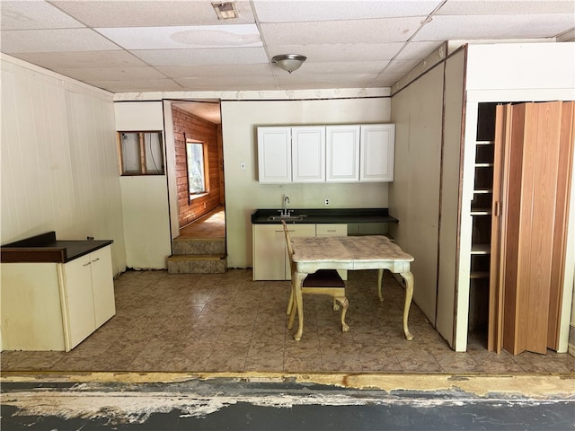 dining area with a paneled ceiling