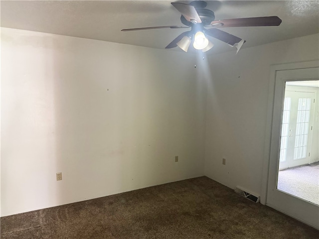spare room featuring carpet floors and ceiling fan