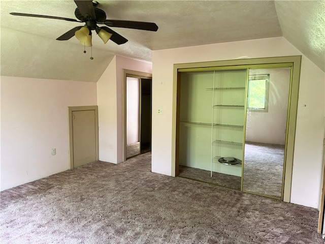 bonus room featuring vaulted ceiling, carpet flooring, a ceiling fan, and a textured ceiling