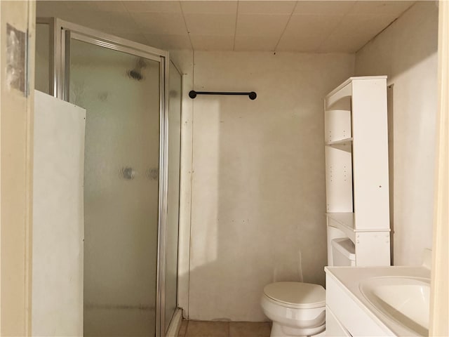 bathroom with a shower stall, tile patterned floors, toilet, and vanity