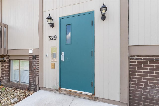 view of exterior entry with brick siding