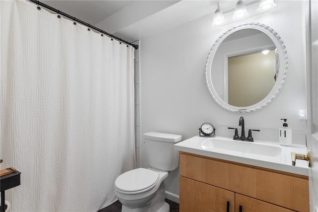 bathroom featuring toilet, vanity, and a shower with shower curtain