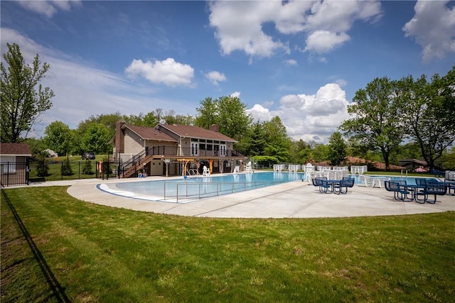 community pool with stairs, a patio, and a wooden deck