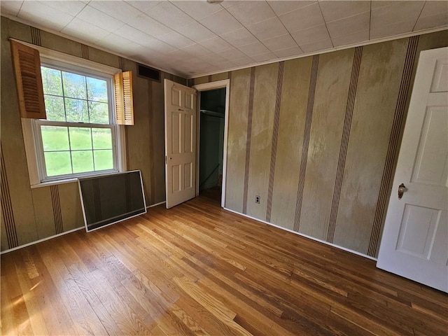 256 Duff Rd, Penn Hills, PA 15235 - unfurnished bedroom featuring wood finished floors and wood walls