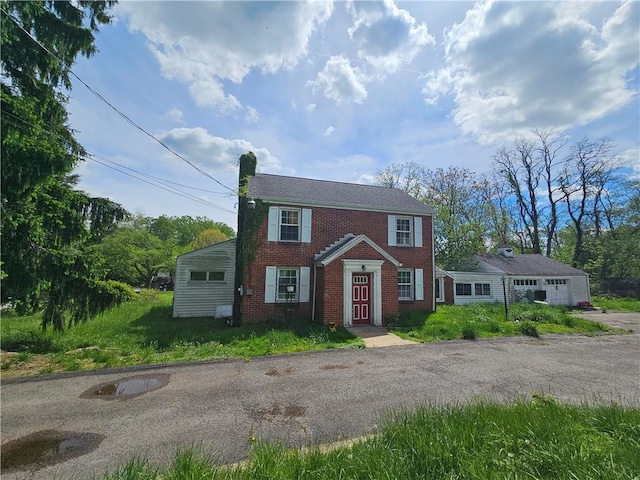 256 Duff Rd, Penn Hills, PA 15235 - view of front of property with brick siding, a chimney, a garage, and asphalt driveway