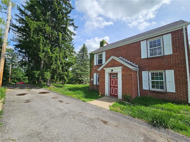 256 Duff Rd, Penn Hills, PA 15235 - view of front facade featuring brick siding, a chimney, and driveway