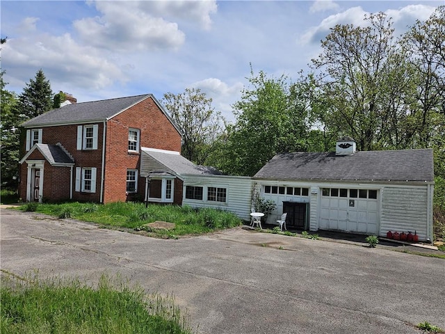 256 Duff Rd, Penn Hills, PA 15235 - view of front of home featuring a chimney, brick siding, and an outbuilding