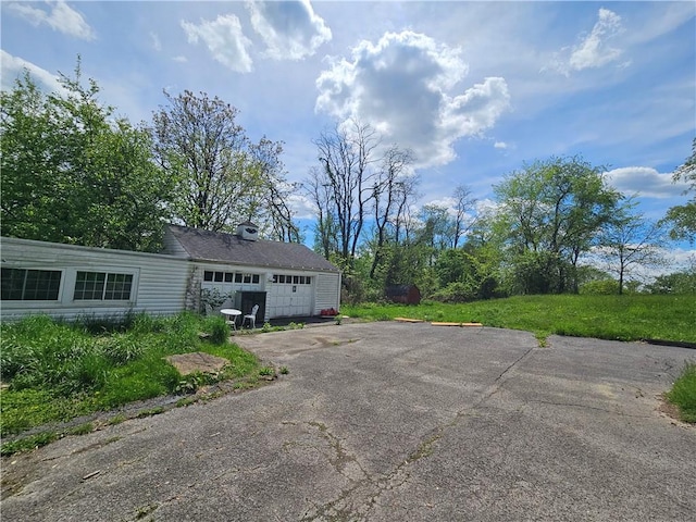 256 Duff Rd, Penn Hills, PA 15235 - view of front of house featuring asphalt driveway and a garage