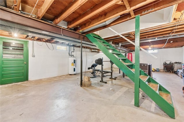 unfinished basement with electric water heater and stairway