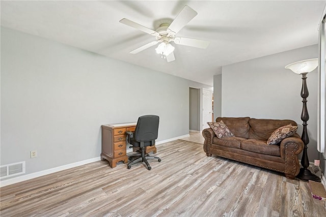 office space featuring light wood-style floors, baseboards, and ceiling fan