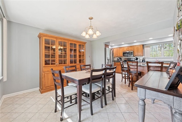 dining room featuring a chandelier, recessed lighting, light tile patterned flooring, and baseboards