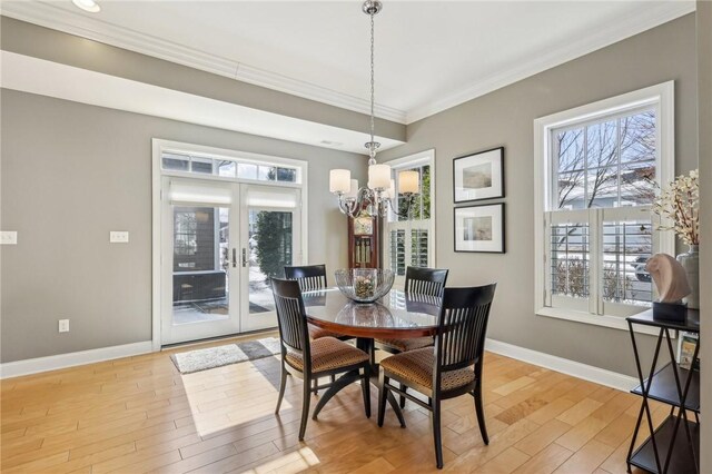 1241 Newbury Highland, South Fayette, PA 15017 - dining space with a chandelier, healthy amount of natural light, ornamental molding, and light wood-type flooring