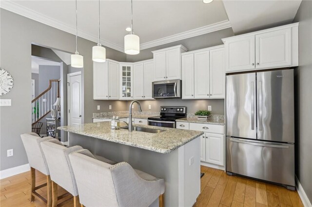 1241 Newbury Highland, South Fayette, PA 15017 - kitchen with appliances with stainless steel finishes, a sink, light wood-style floors, ornamental molding, and light stone countertops